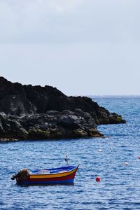 Boat in sea against sky