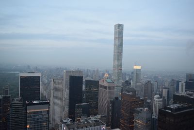 Skyscrapers against cloudy sky