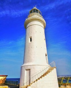 Low angle view of water tower against blue sky