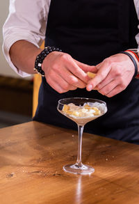 Midsection of man holding wineglass