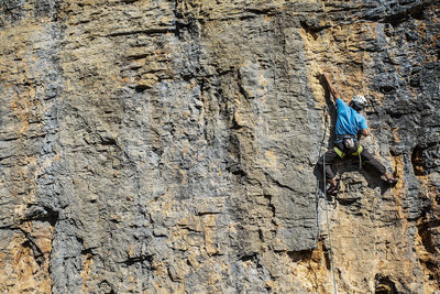 Low angle view of person standing on rock