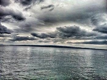 Scenic view of sea against cloudy sky