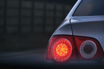 Close-up of illuminated lighting equipment on road