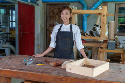 Portrait of beautiful asian woman carpenter dealing with handicraft