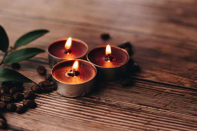 High angle view of lit candles on table