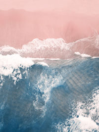 Aerial view of a pink sandy beach