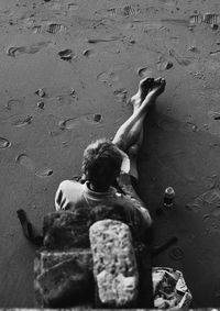 Low section of boy on sand at beach