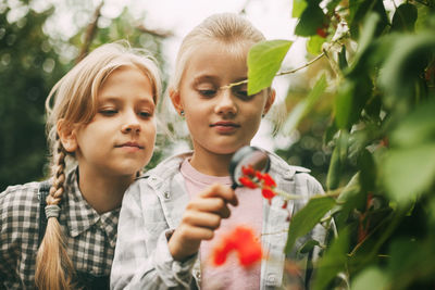 Portrait of friends against plants