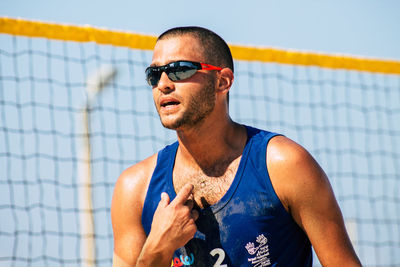 Young man wearing sunglasses looking away