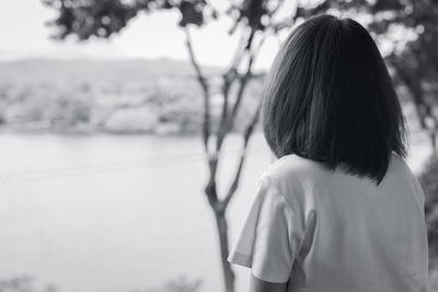 Back view of sad asian woman in the park look the view of lake. depressed woman. mental health 