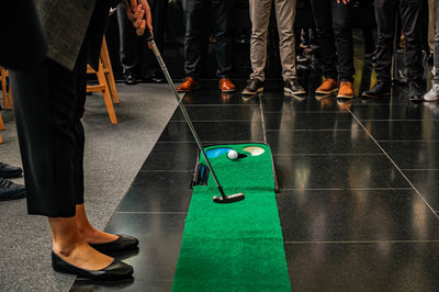 Low section of people socializing and playing golf