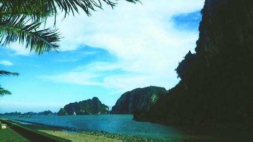 Panoramic shot of sea and mountains against sky