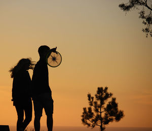 Silhouette of people at sunset