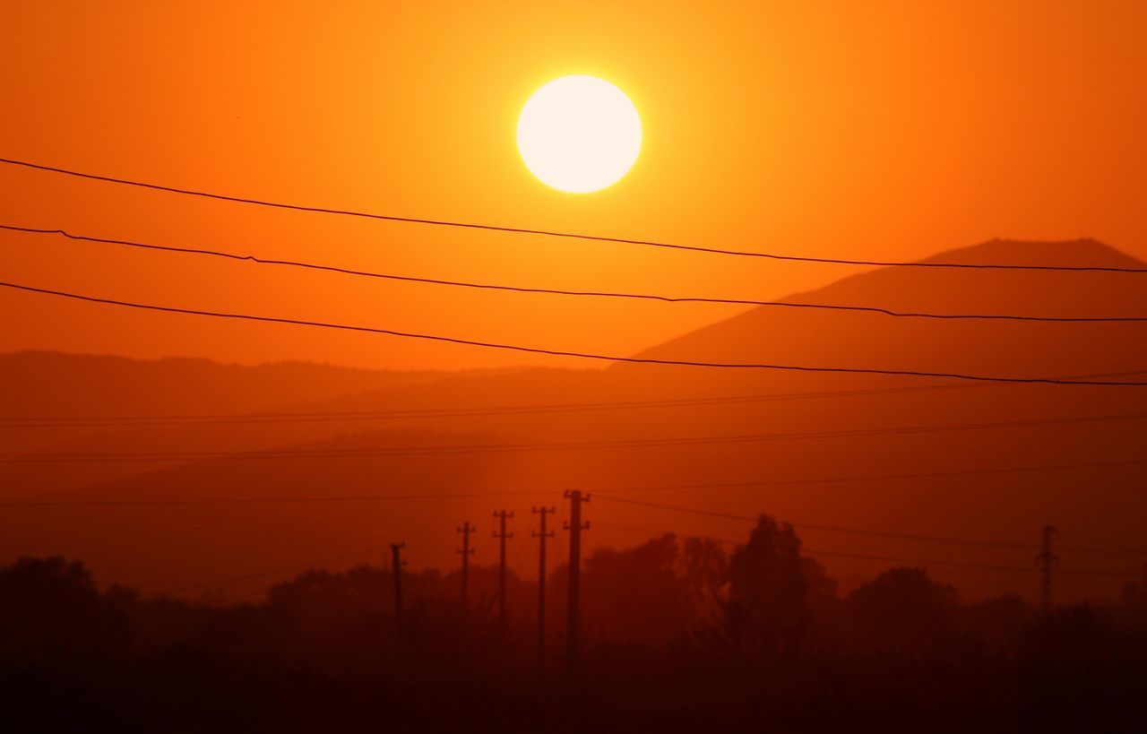 sunset, power line, orange color, electricity pylon, power supply, silhouette, electricity, connection, cable, scenics, tranquility, sun, tranquil scene, beauty in nature, fuel and power generation, sky, nature, landscape, idyllic, technology