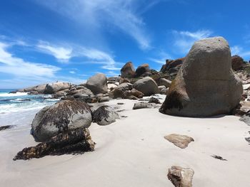 Rocks on beach against sky