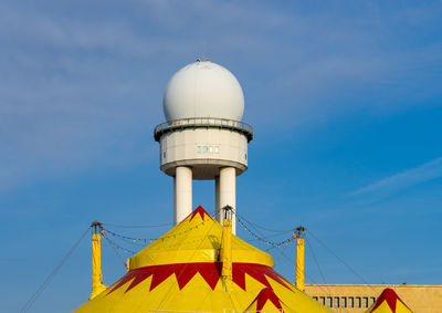 Low angle view of tower against blue sky