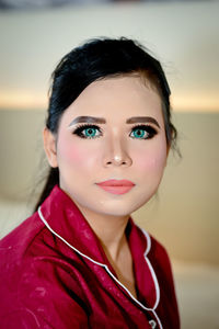 Close-up portrait of young woman wearing make-up