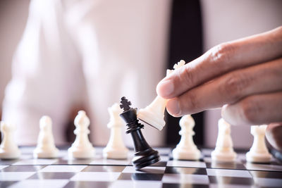 Midsection of man playing chess