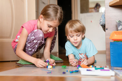 Children playing with toy on table