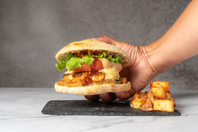 Cropped hand of person holding food