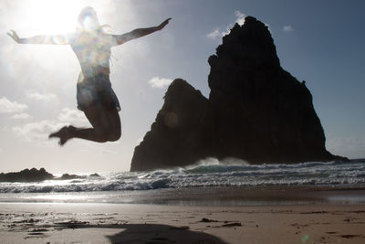 Man surfing in sea against sky