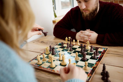 Midsection of couple sitting on table