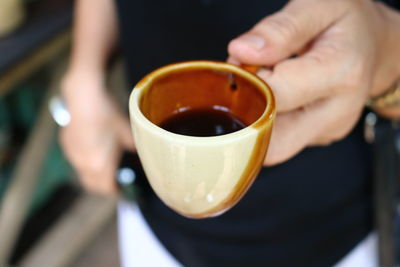 Cropped image of man holing espresso cup