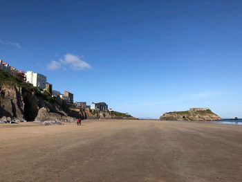 Scenic view of beach against blue sky