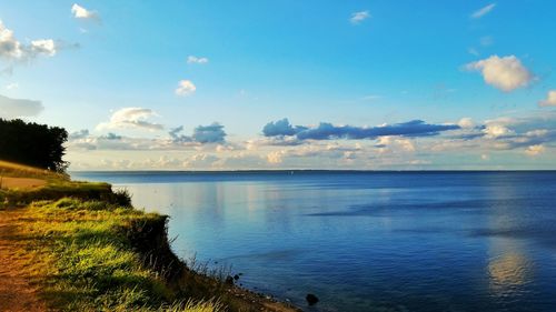 Scenic view of sea against cloudy sky