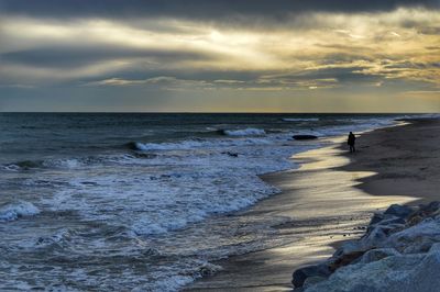 Scenic view of beach against sky during sunset