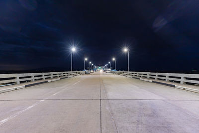 Illuminated street lights on bridge at night