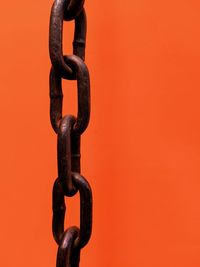 Close-up of chain against yellow background