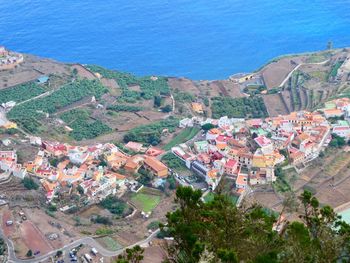 High angle view of townscape by sea