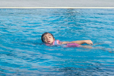 Portrait of boy swimming in pool