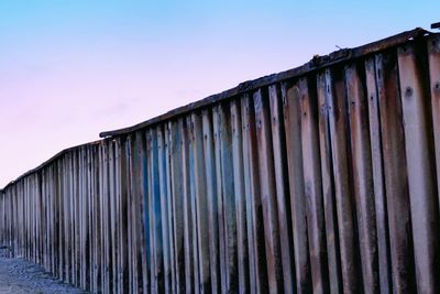 Low angle view of rusty metallic structure against sky