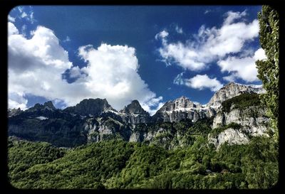 Scenic view of mountains against cloudy sky