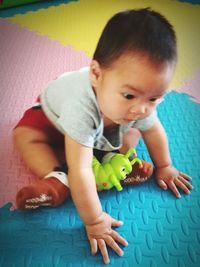 Close-up of baby playing with toy at home