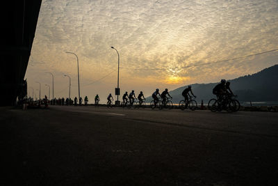 People on road at sunset