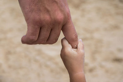 Low section of woman feet on sand at beach