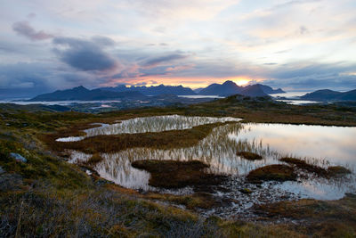 Scenic view of lake against sky during sunset