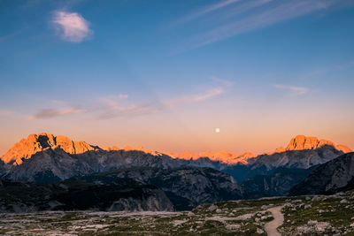 Scenic view of snowcapped mountains against sky during sunset