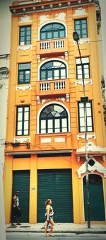 Full length of woman standing in front of building