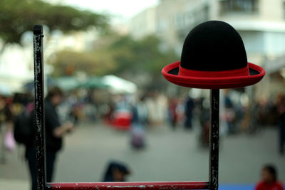 Close-up of hat on metal against street