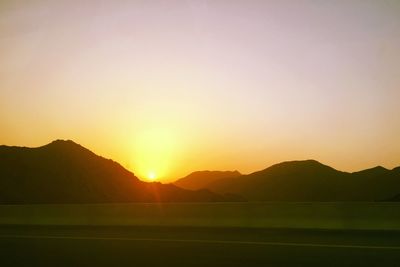 Scenic view of silhouette mountains against sky during sunset