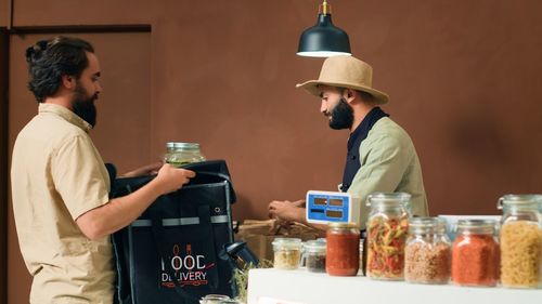 Rear view of man working at table