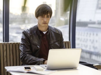 Businessman works with laptop and paper organiser in co-working center. workplace for freelancers.