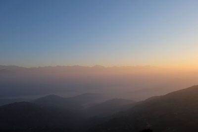 Scenic view of silhouette mountains against sky during sunset