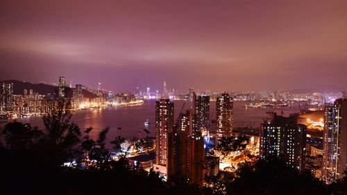 High angle view of illuminated buildings against sky at night