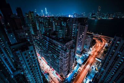 High angle view of illuminated cityscape against sky at night