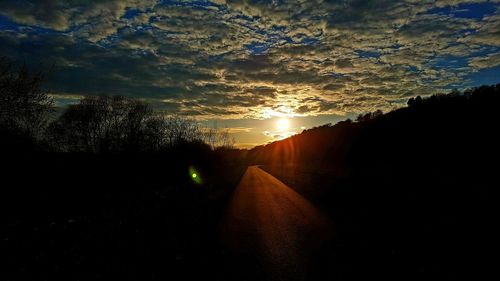 Close-up of silhouette sun against sky during sunset